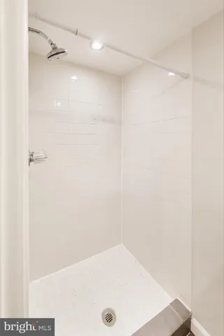 a view of a room with wooden floor and brick walls