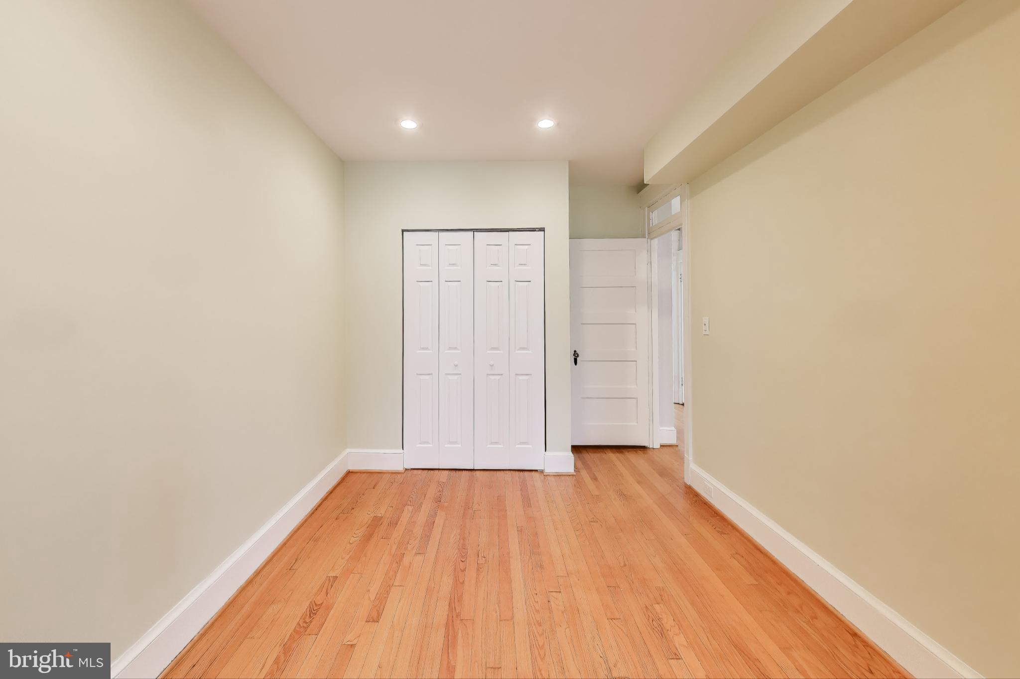 628 Madison Street Northwest Washington, DC 20011 - Photo 30 of 47 a view of a room with wooden floor and brick walls