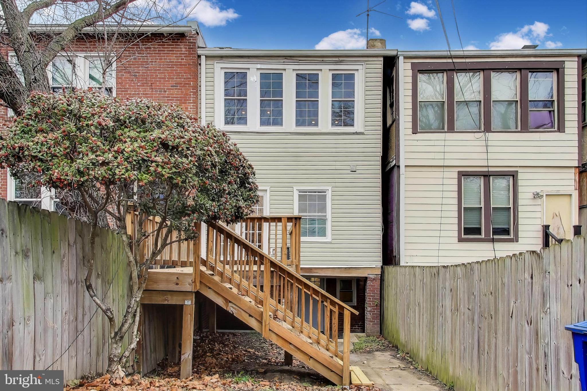 628 Madison Street Northwest Washington, DC 20011 - Photo 40 of 47 a view of a house with wooden stairs and a small yard