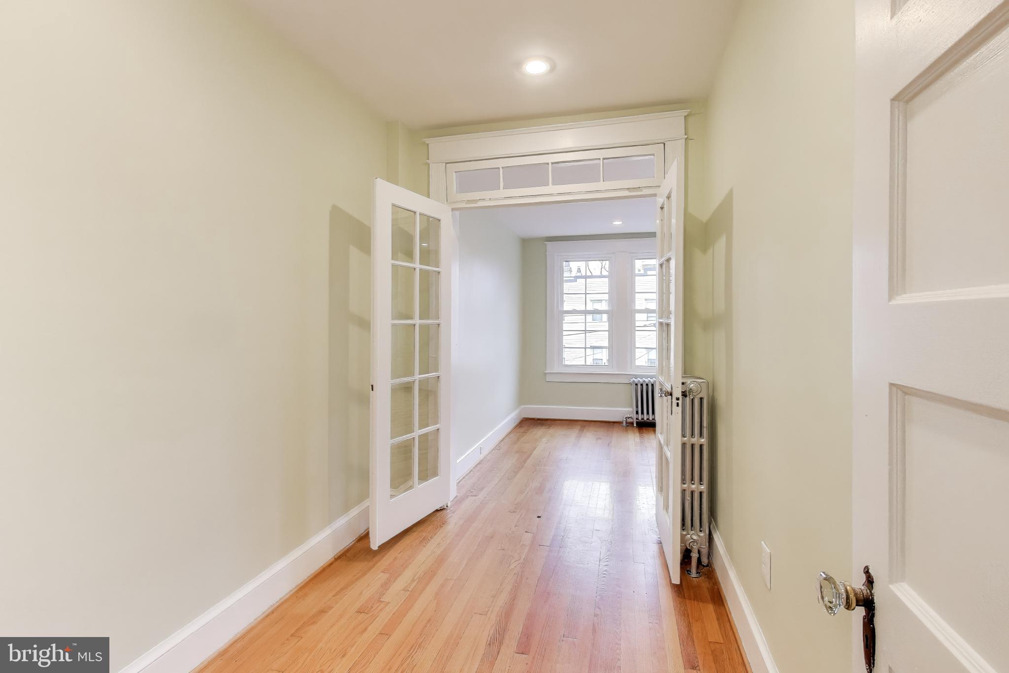 628 Madison Street Northwest Washington, DC 20011 - Photo 5 of 47 an empty room with wooden floor and windows