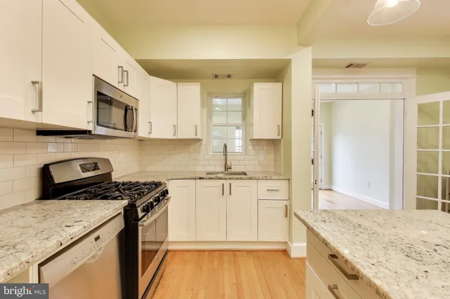 a view of kitchen with cabinets and wooden floor