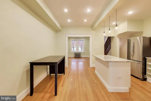 a view of an entryway with wooden floor