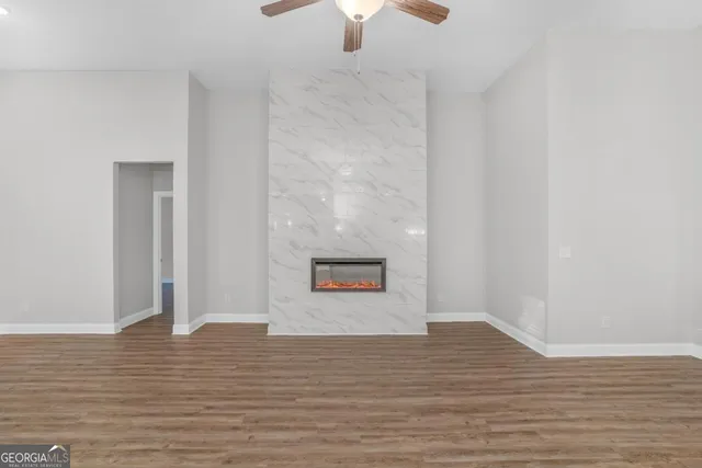a view of a room with wooden floor window and a fireplace