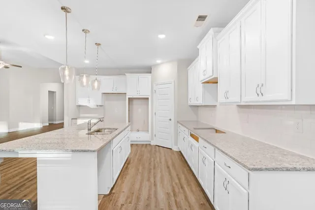 a kitchen with kitchen island a sink stove and refrigerator