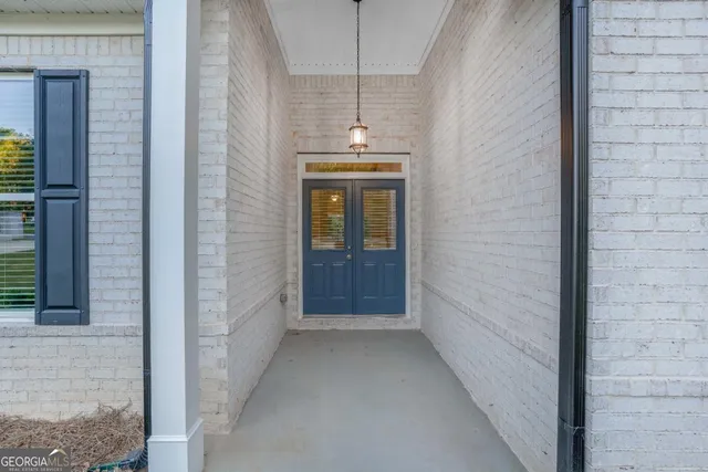 a view of a hallway with wooden walls and windows