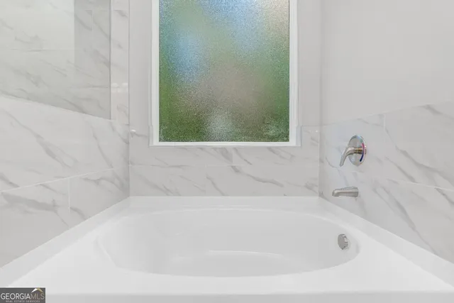 a white bath tub sitting next to a window