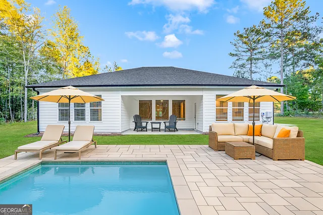 a view of swimming pool with lounge chair