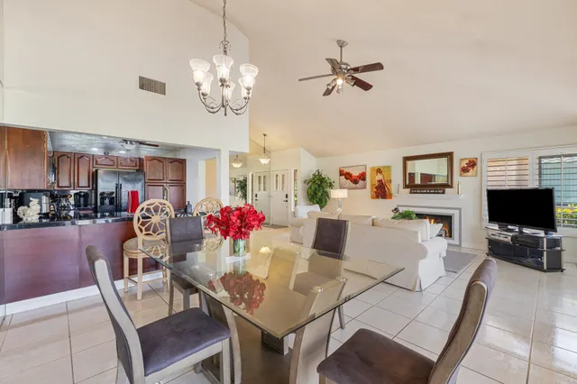 a view of a dining room with furniture and a chandelier