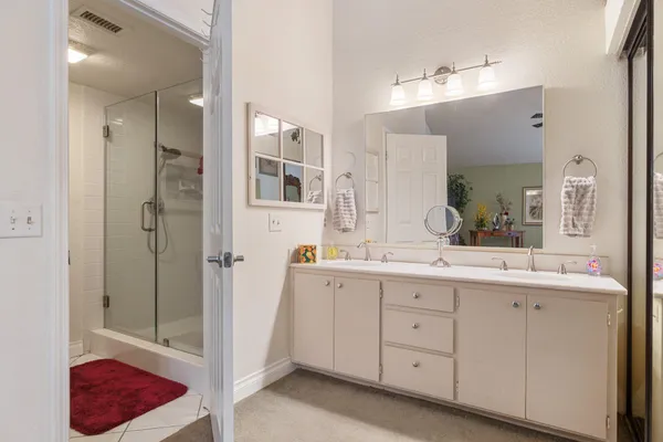 a spacious bathroom with a granite countertop sink mirror and double
