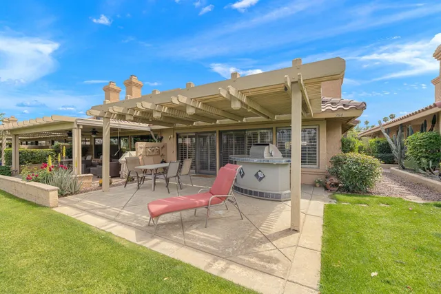 a view of a house with backyard porch and sitting area