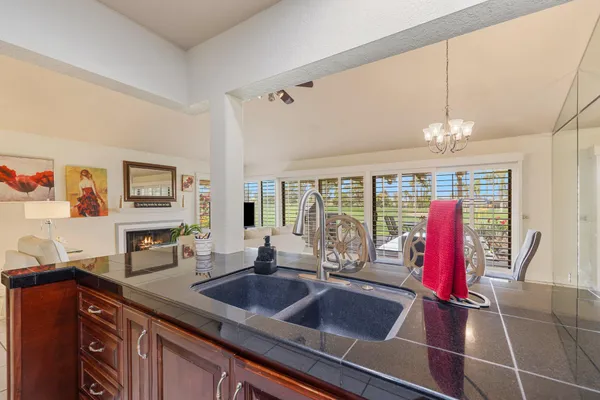 a kitchen with a sink and a large window