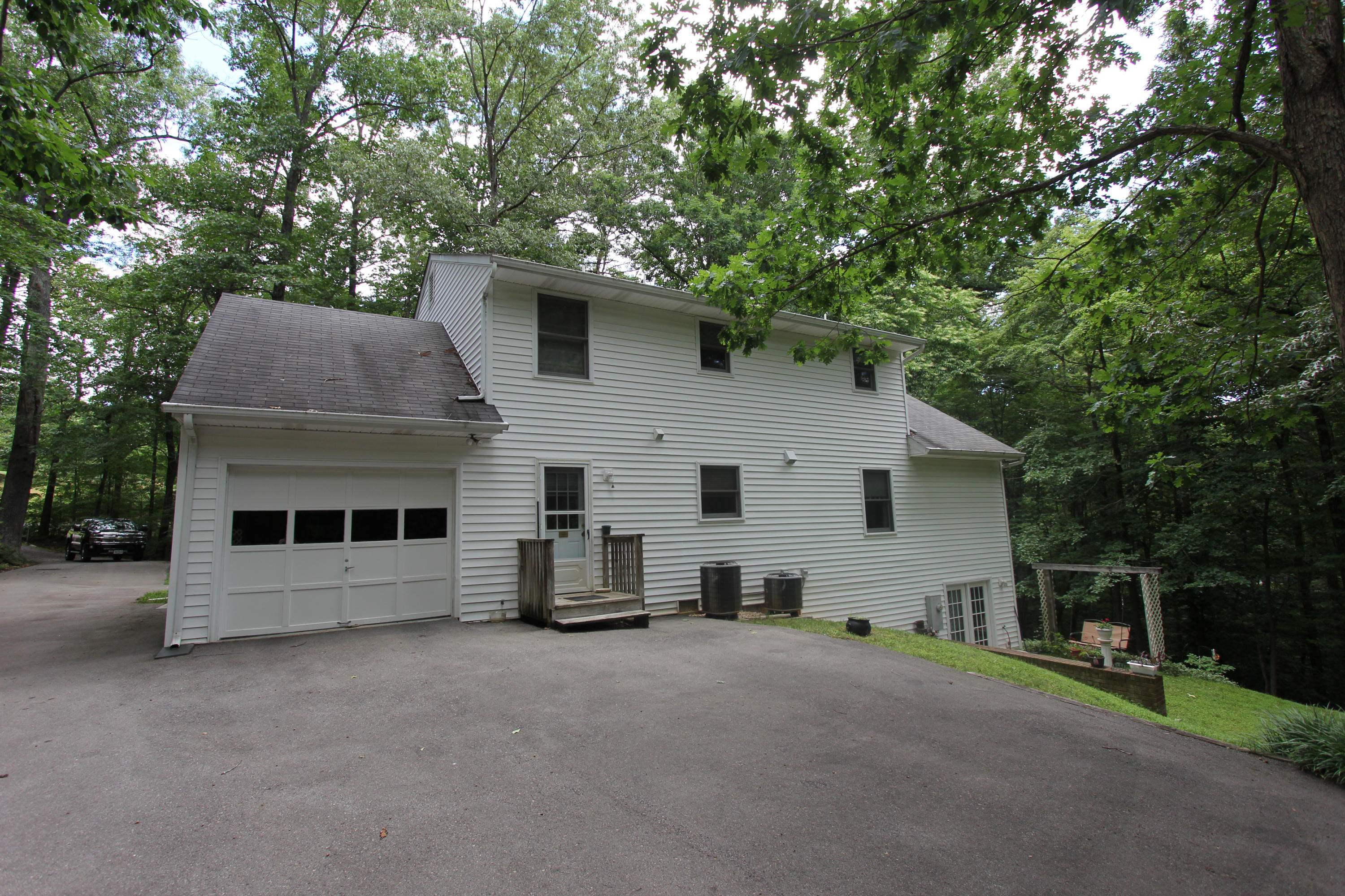 13173 Hardy Road Hardy, VA 24101 - Photo 4 of 14 a front view of house with yard and trees in the background