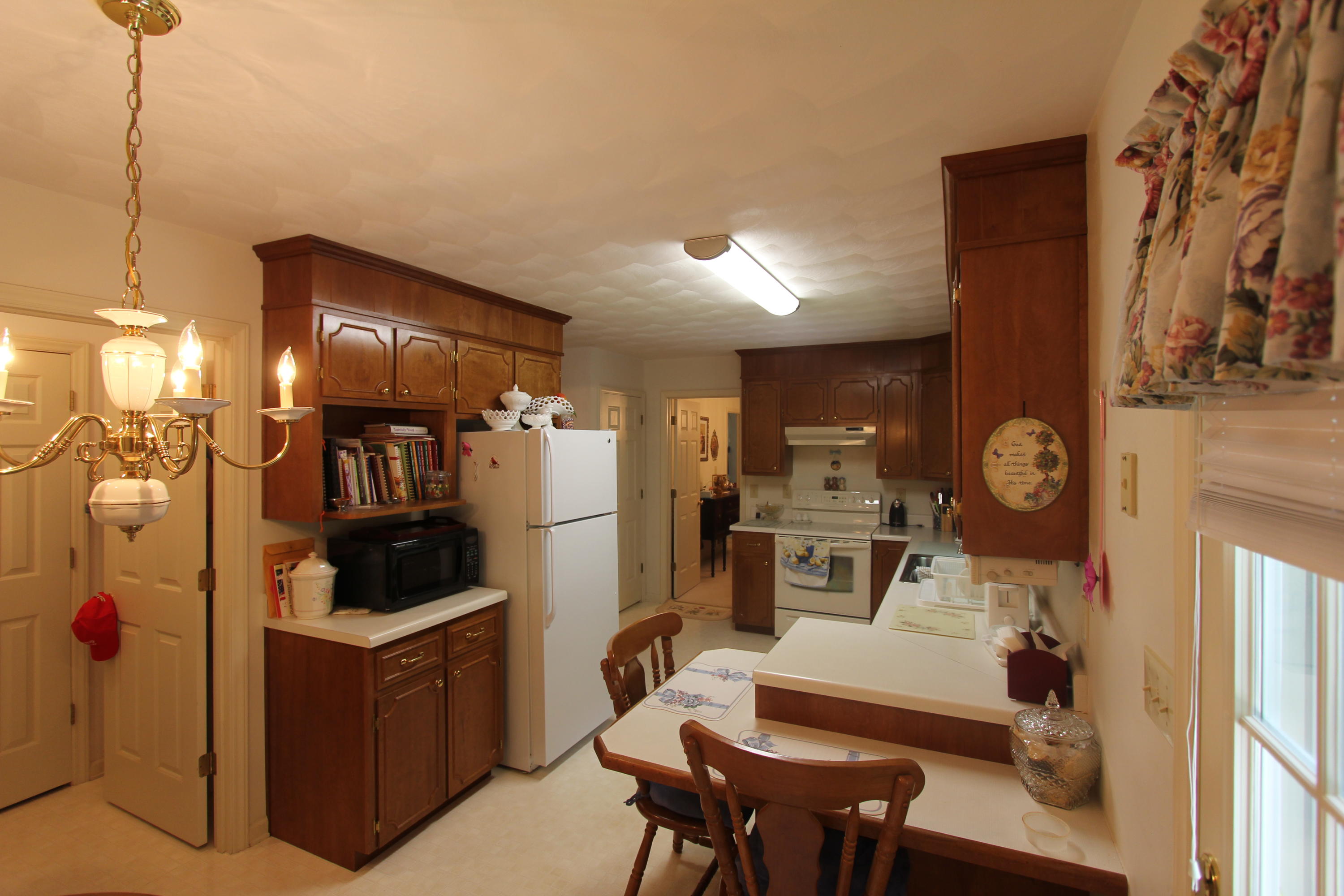13173 Hardy Road Hardy, VA 24101 - Photo 6 of 14 a kitchen with a refrigerator and chairs