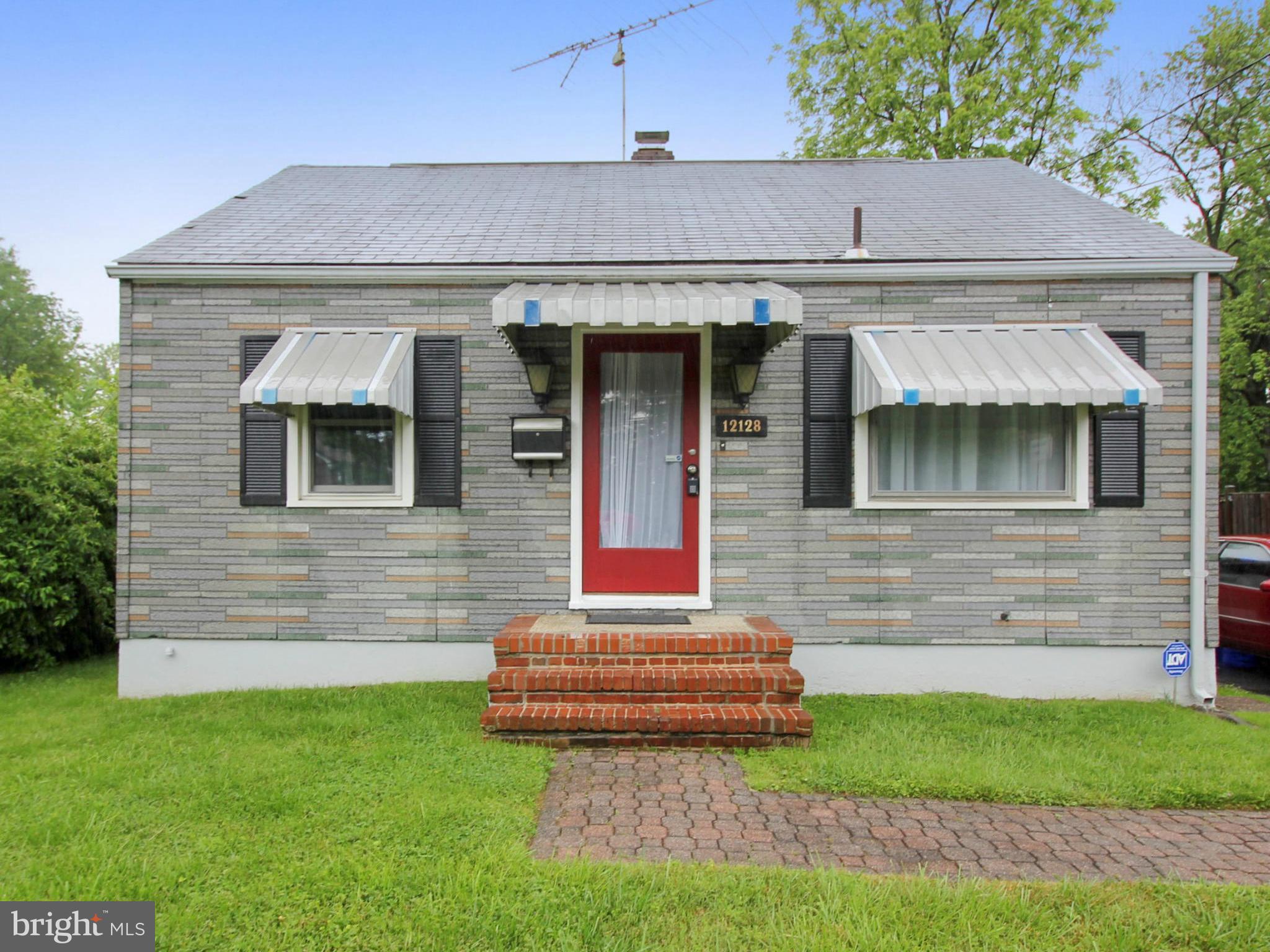 12128 Veirs Mill Road Silver Spring, MD 20906 - Photo 1 of 30 a front view of a house with a garden