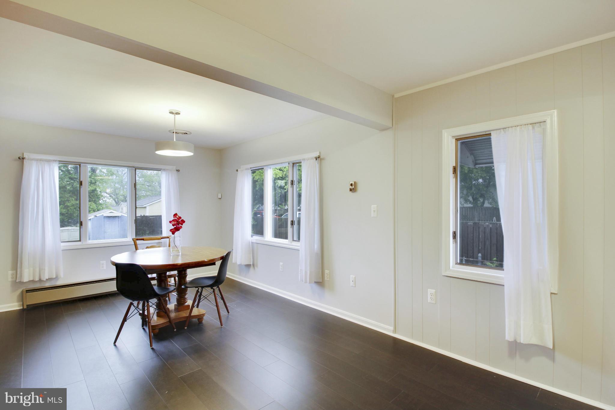 12128 Veirs Mill Road Silver Spring, MD 20906 - Photo 11 of 30 a dining room with furniture and wooden floor