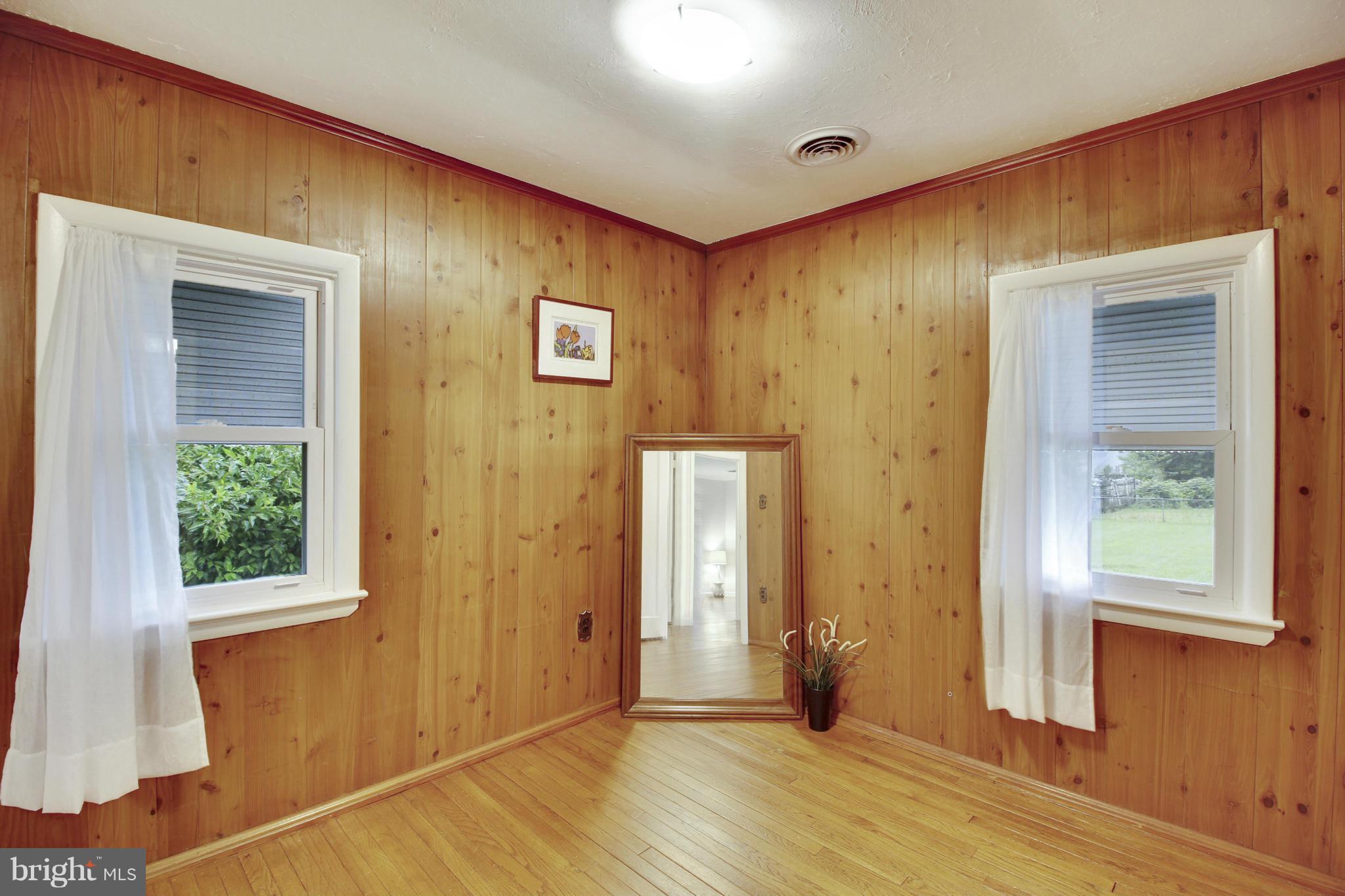 12128 Veirs Mill Road Silver Spring, MD 20906 - Photo 17 of 30 an empty room with wooden floor and windows