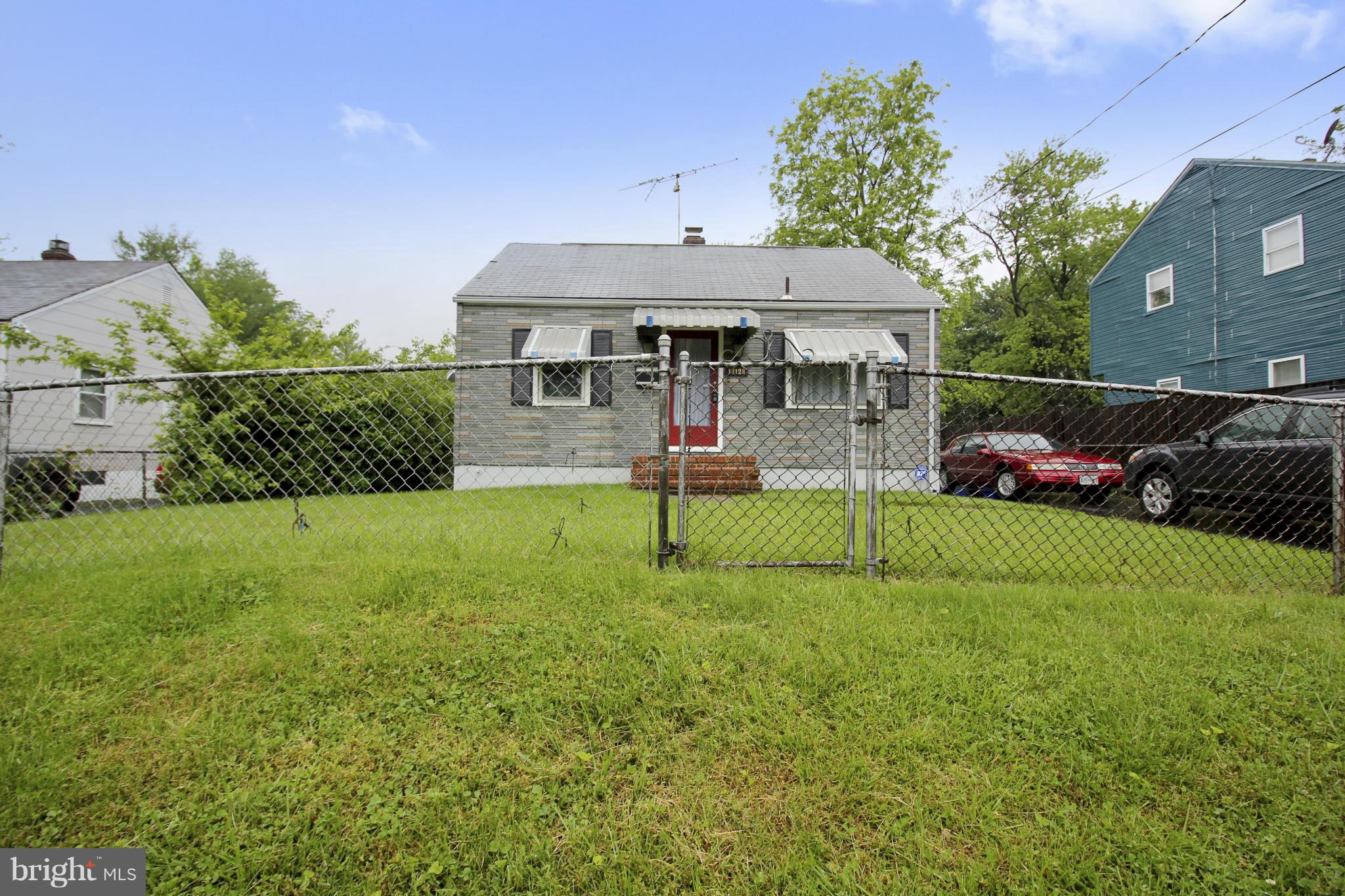 12128 Veirs Mill Road Silver Spring, MD 20906 - Photo 25 of 30 a front view of a house with a yard