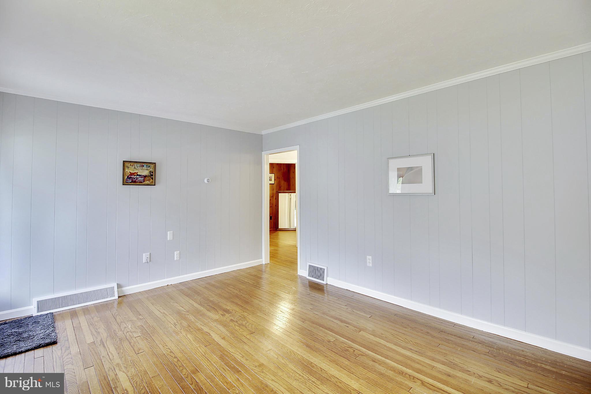 12128 Veirs Mill Road Silver Spring, MD 20906 - Photo 6 of 30 a view of an empty room with wooden floor