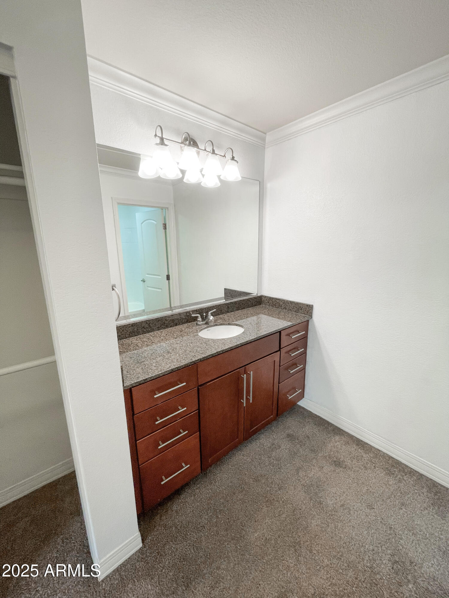 2025 East Campbell Avenue, Unit 312 Phoenix, AZ 85016 - Photo 12 of 16 a spacious bathroom with a granite countertop sink and a mirror