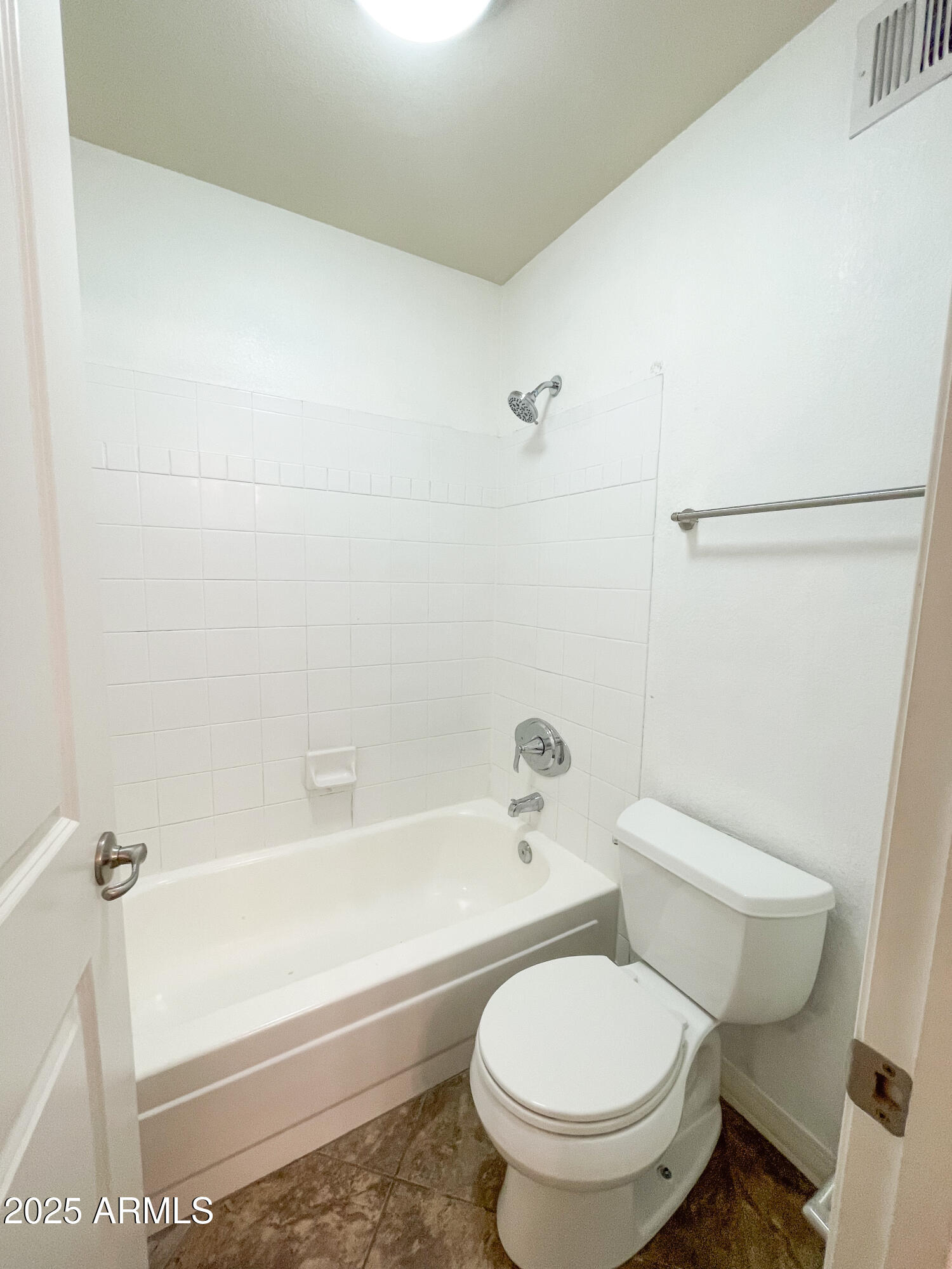 2025 East Campbell Avenue, Unit 312 Phoenix, AZ 85016 - Photo 13 of 16 a white toilet sitting next to a bath tub