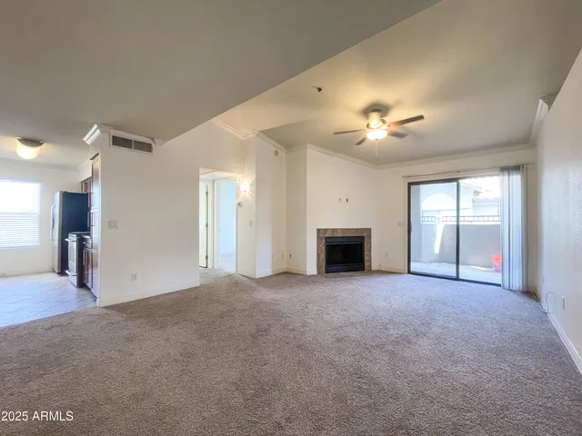 a view of an empty room with a fireplace