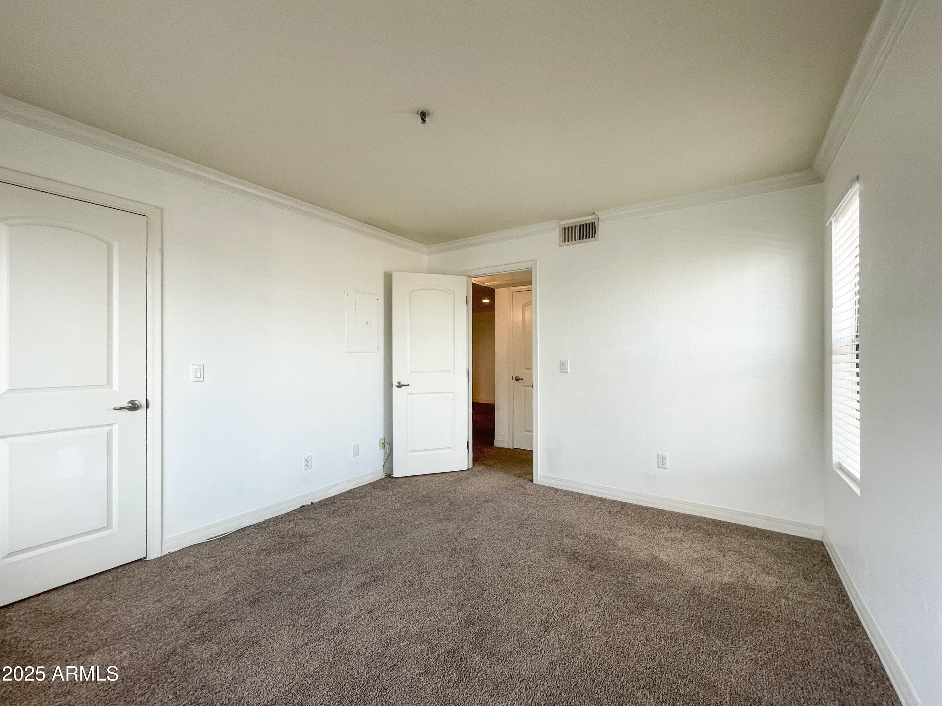 2025 East Campbell Avenue, Unit 312 Phoenix, AZ 85016 - Photo 8 of 16 a view of an empty room and window