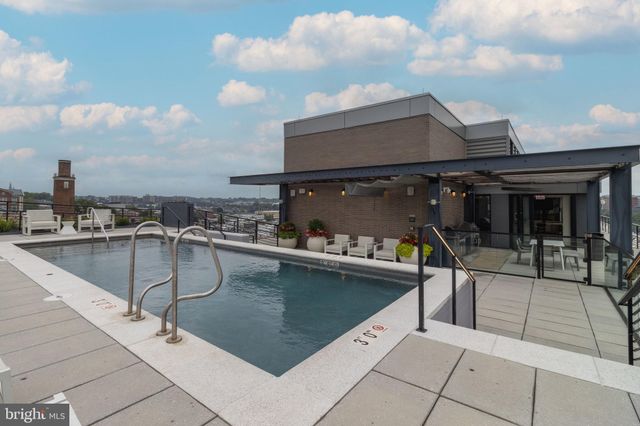 a roof deck with table and chairs