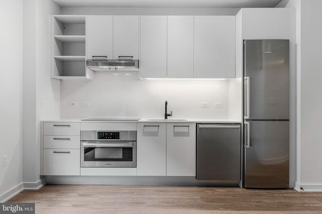 a kitchen with stainless steel appliances a refrigerator and a stove