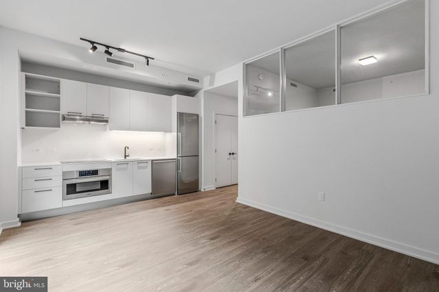 a view of a kitchen with a stove cabinets and a wooden floor