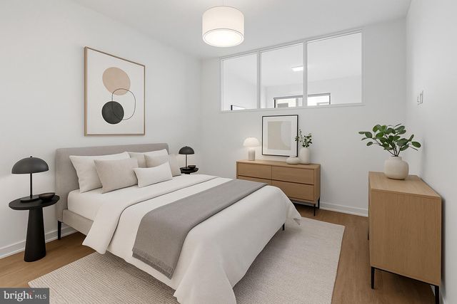 a bedroom with a bed and a painting