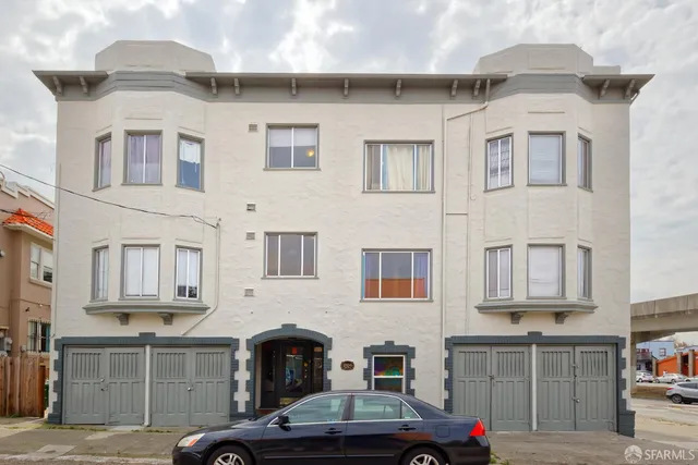 a front view of residential houses with cars