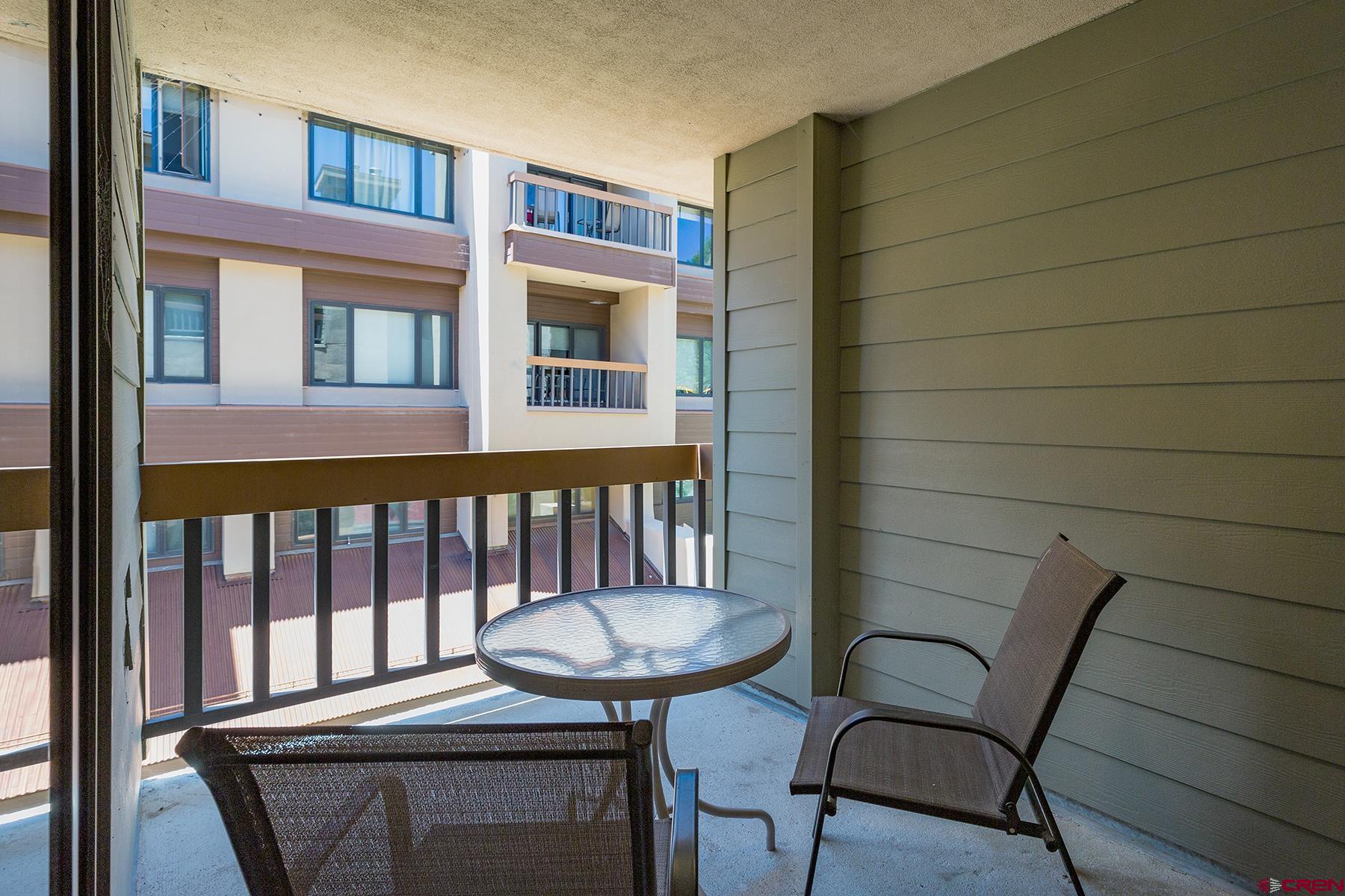 71 Needles Way, Unit 443 Durango, CO 81301 - Photo 12 of 26 a view of a chair and table in the balcony