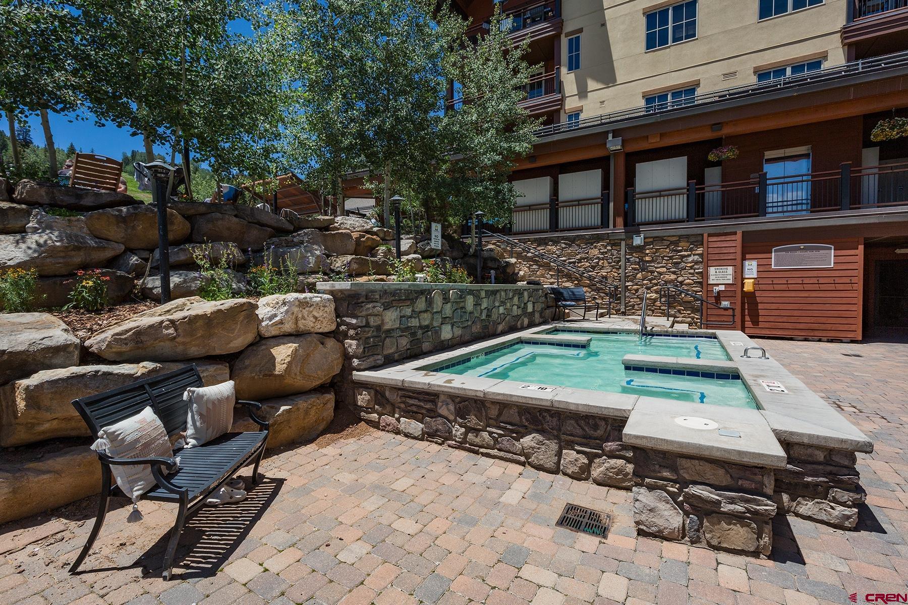 71 Needles Way, Unit 443 Durango, CO 81301 - Photo 15 of 26 a backyard of a house with yard fire pit barbeque oven and outdoor seating