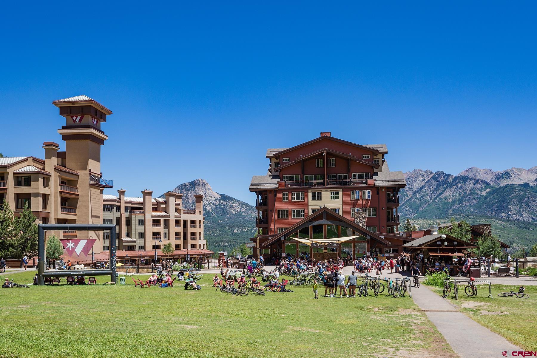 71 Needles Way, Unit 443 Durango, CO 81301 - Photo 16 of 26 a front view of a building with a garden and plants