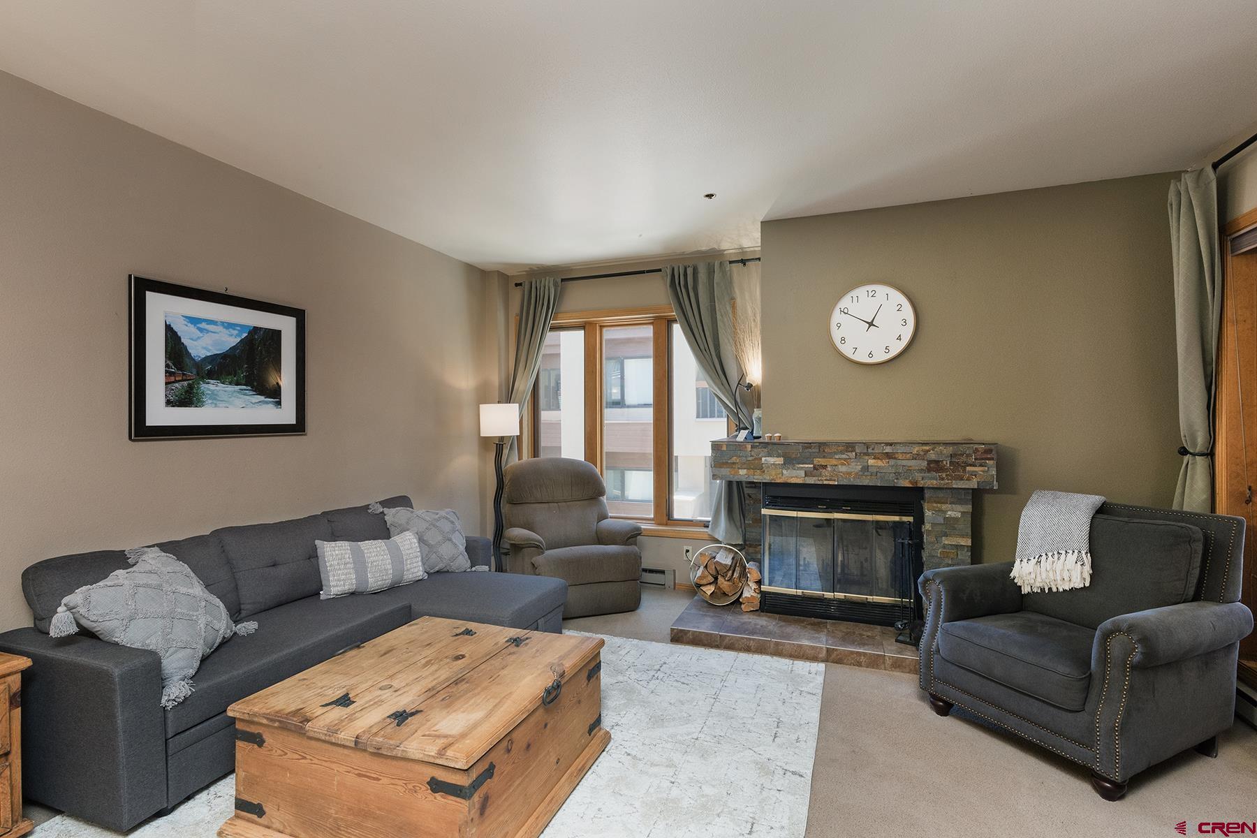 71 Needles Way, Unit 443 Durango, CO 81301 - Photo 2 of 26 a living room with furniture a fireplace and window