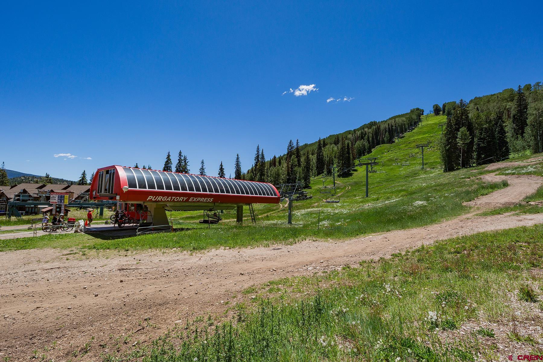 71 Needles Way, Unit 443 Durango, CO 81301 - Photo 21 of 26 a view of a table and chairs in the garden