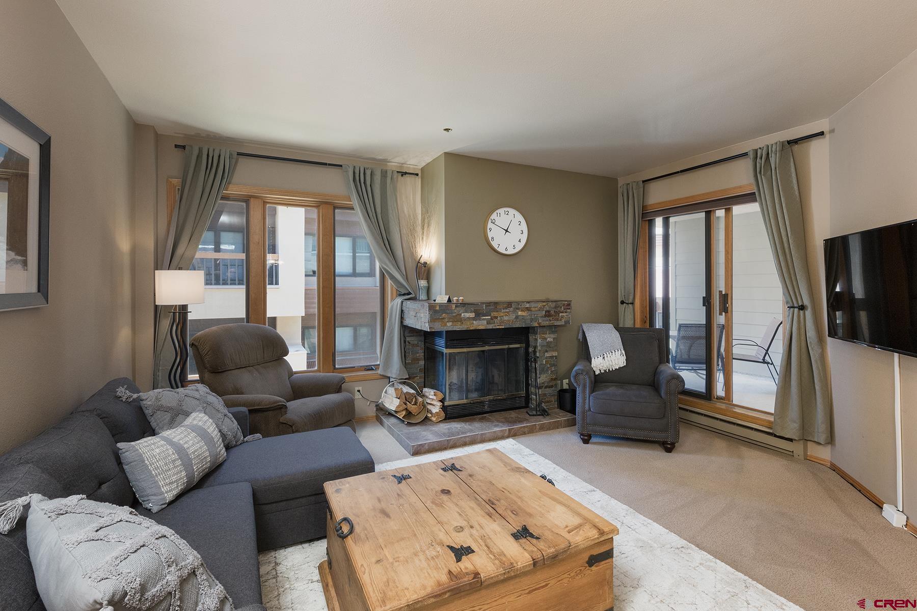 71 Needles Way, Unit 443 Durango, CO 81301 - Photo 3 of 26 a living room with furniture a fireplace and a flat screen tv