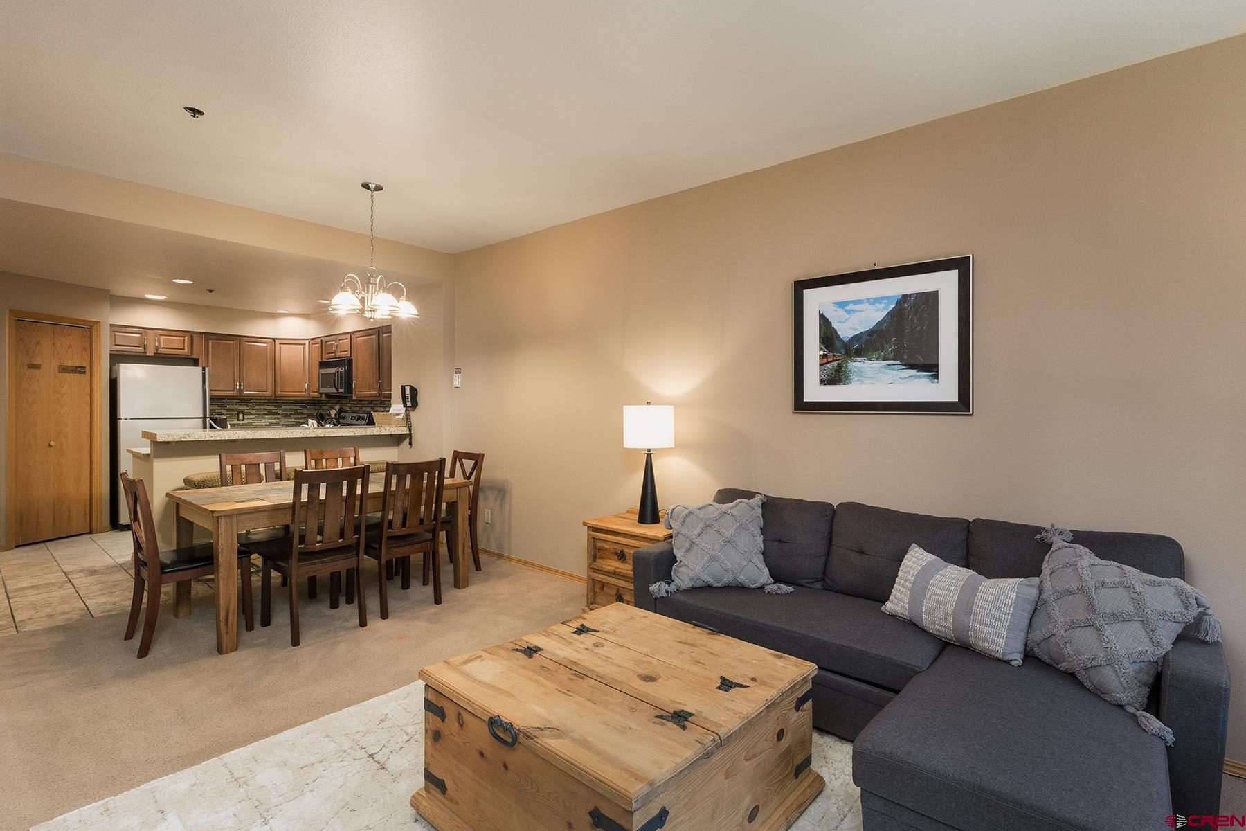 71 Needles Way, Unit 443 Durango, CO 81301 - Photo 4 of 26 a living room with furniture a dining table and kitchen view