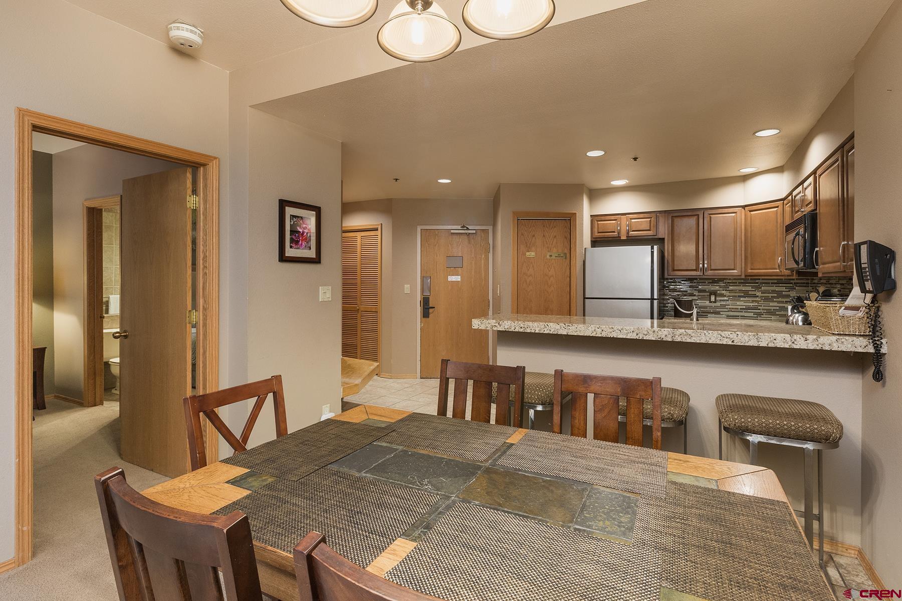 71 Needles Way, Unit 443 Durango, CO 81301 - Photo 5 of 26 a large kitchen with stainless steel appliances granite countertop a granite counter tops and a view of living room