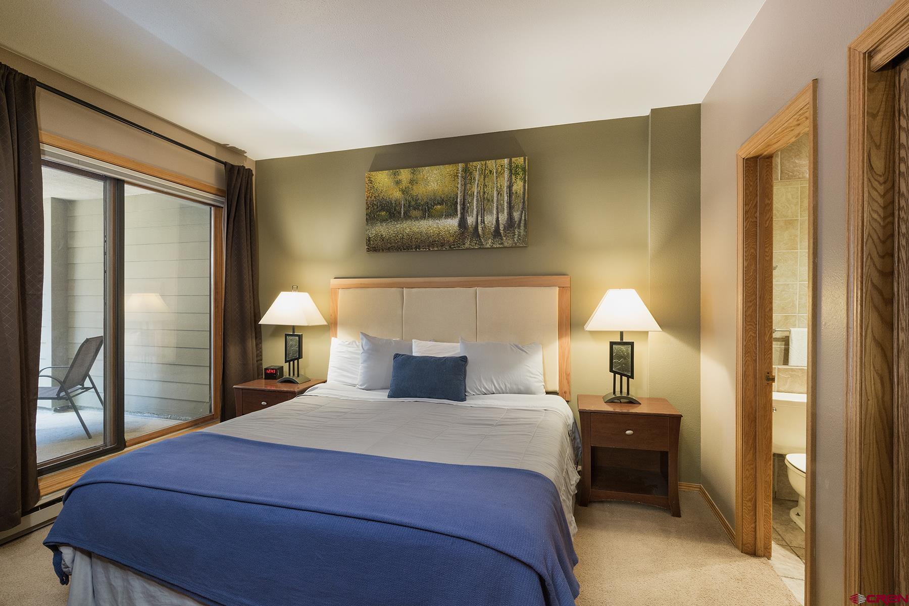 71 Needles Way, Unit 443 Durango, CO 81301 - Photo 8 of 26 a bedroom with a bed and a lamp