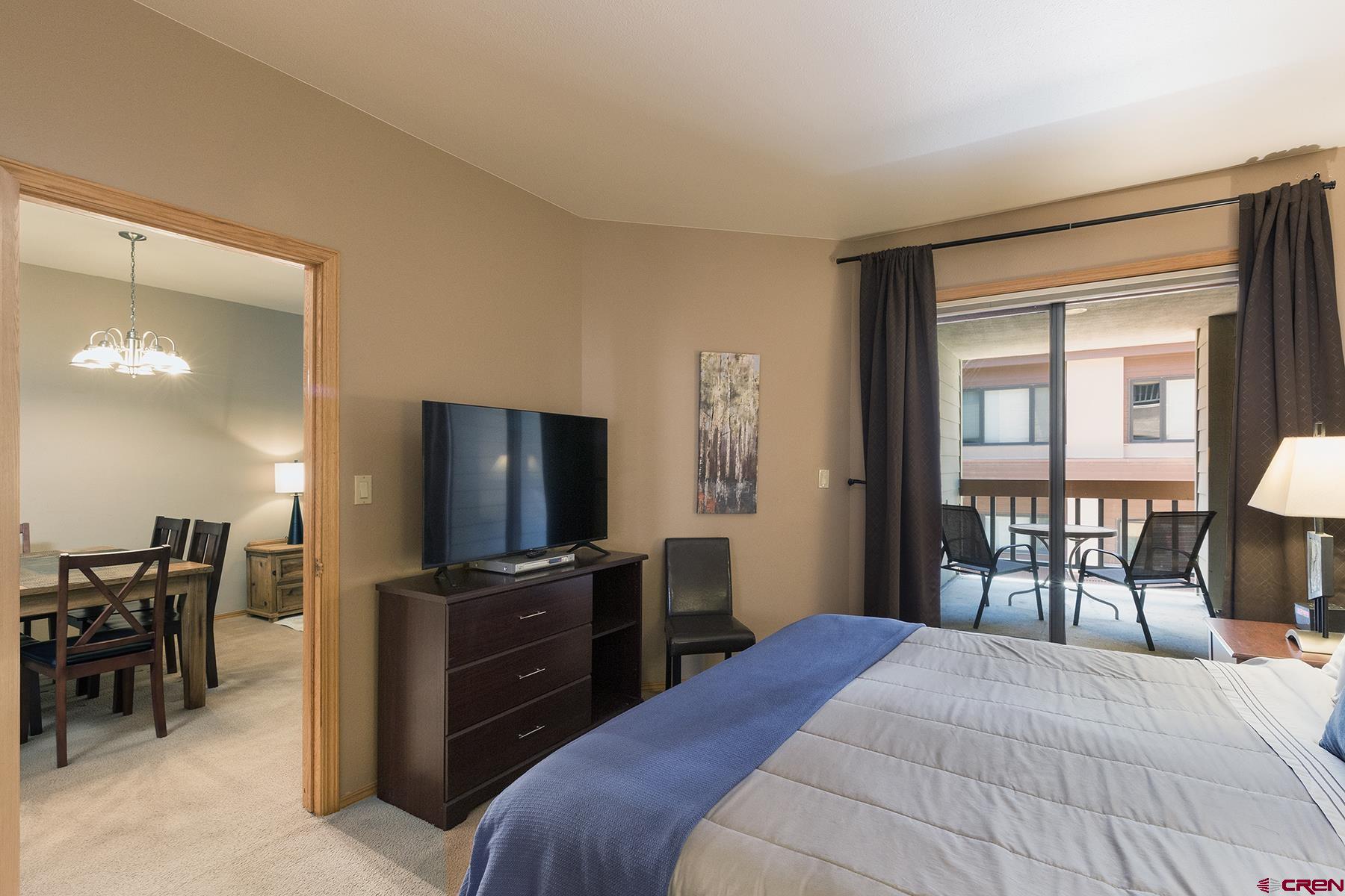 71 Needles Way, Unit 443 Durango, CO 81301 - Photo 9 of 26 a bedroom with a bed and a flat screen tv