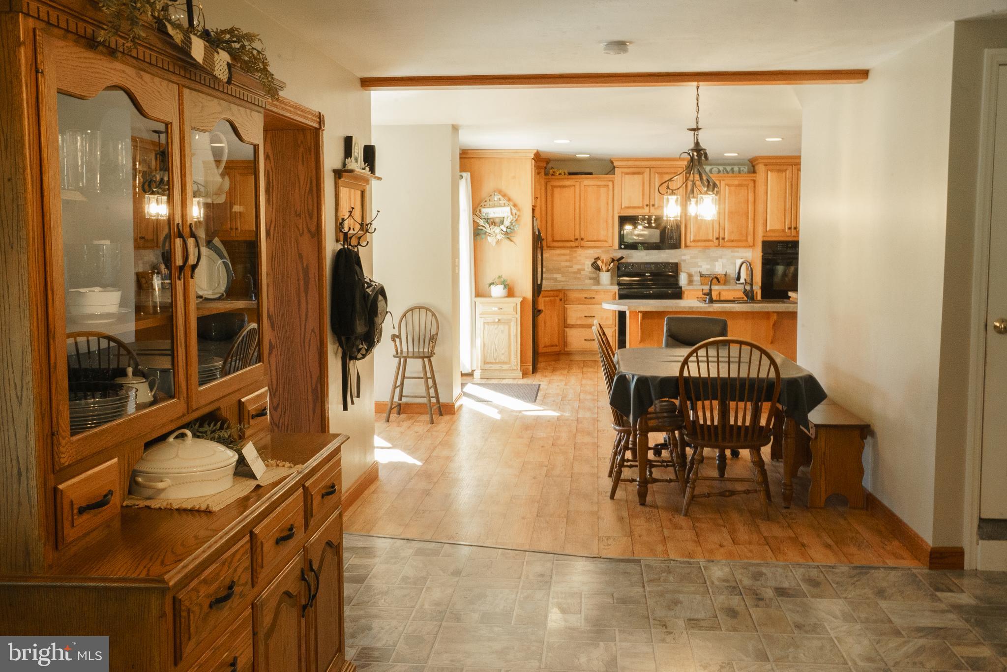 1682 Reading Road Mohnton, PA 19540 - Photo 14 of 73 a dining room with stainless steel appliances a dining table chairs and chandelier