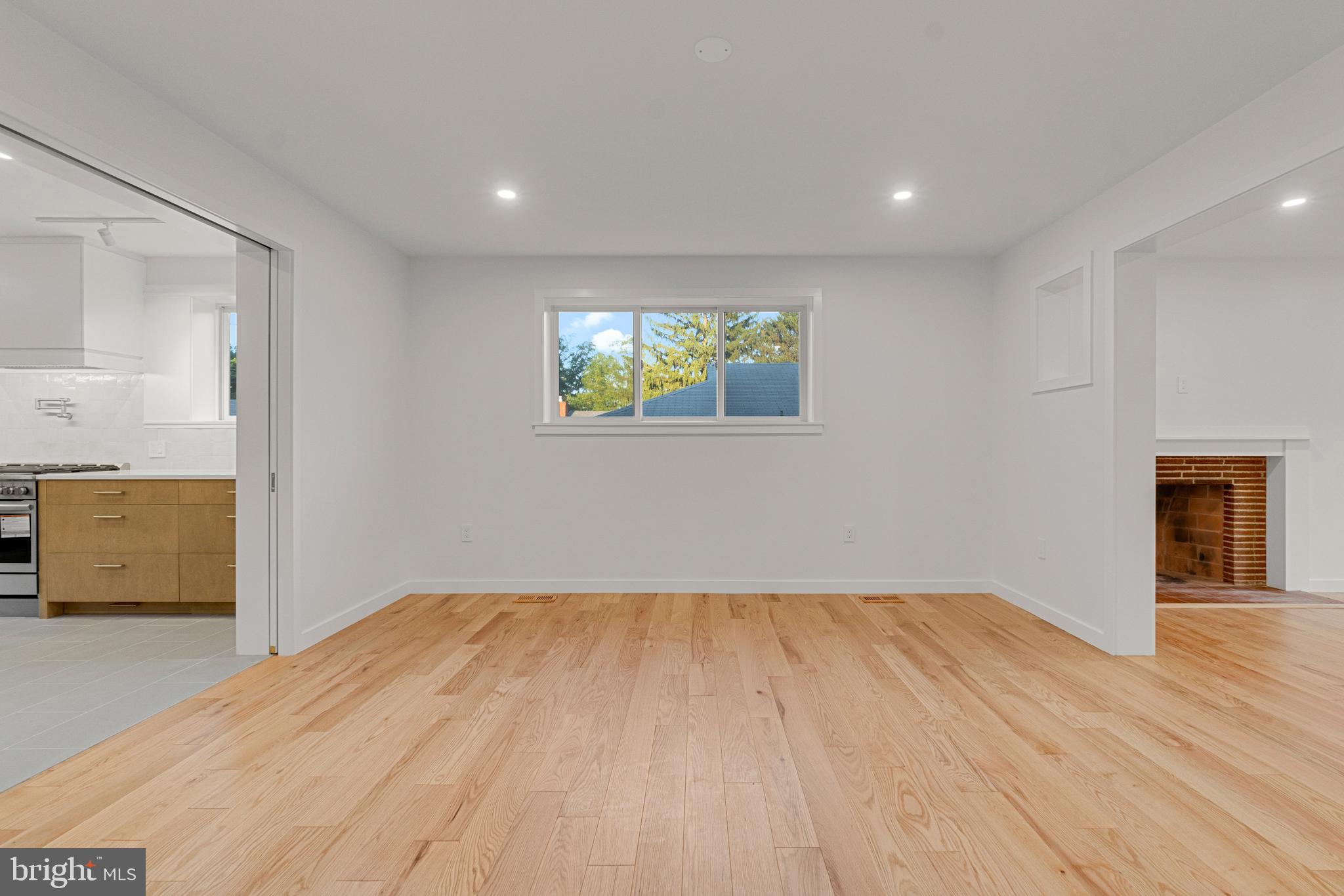 2706 Bartol Avenue Baltimore, MD 21209 - Photo 11 of 62 a view of empty room with wooden floor and window