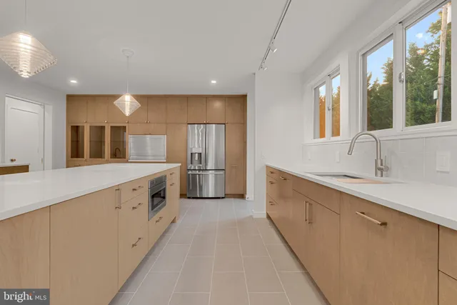 a view of a kitchen with a refrigerator a sink and dishwasher
