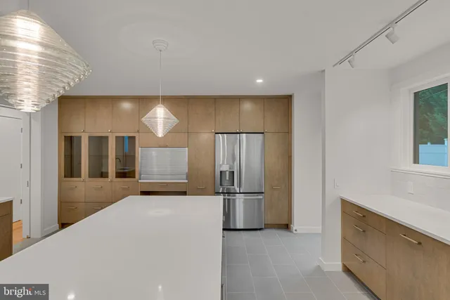 a kitchen with a refrigerator and a sink