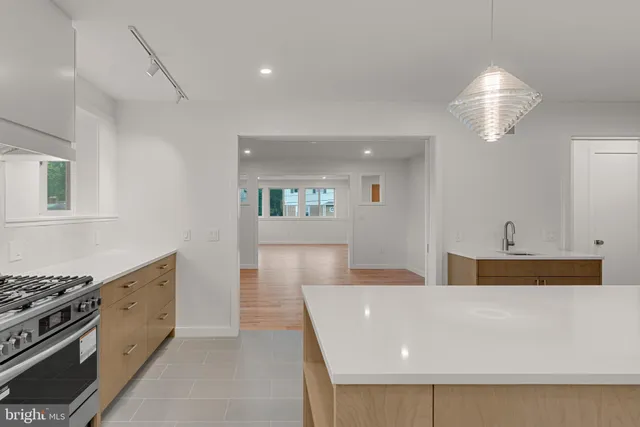a kitchen with stainless steel appliances granite countertop a stove and a sink