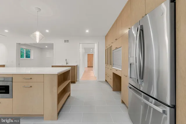 a kitchen with a stove a sink and a window