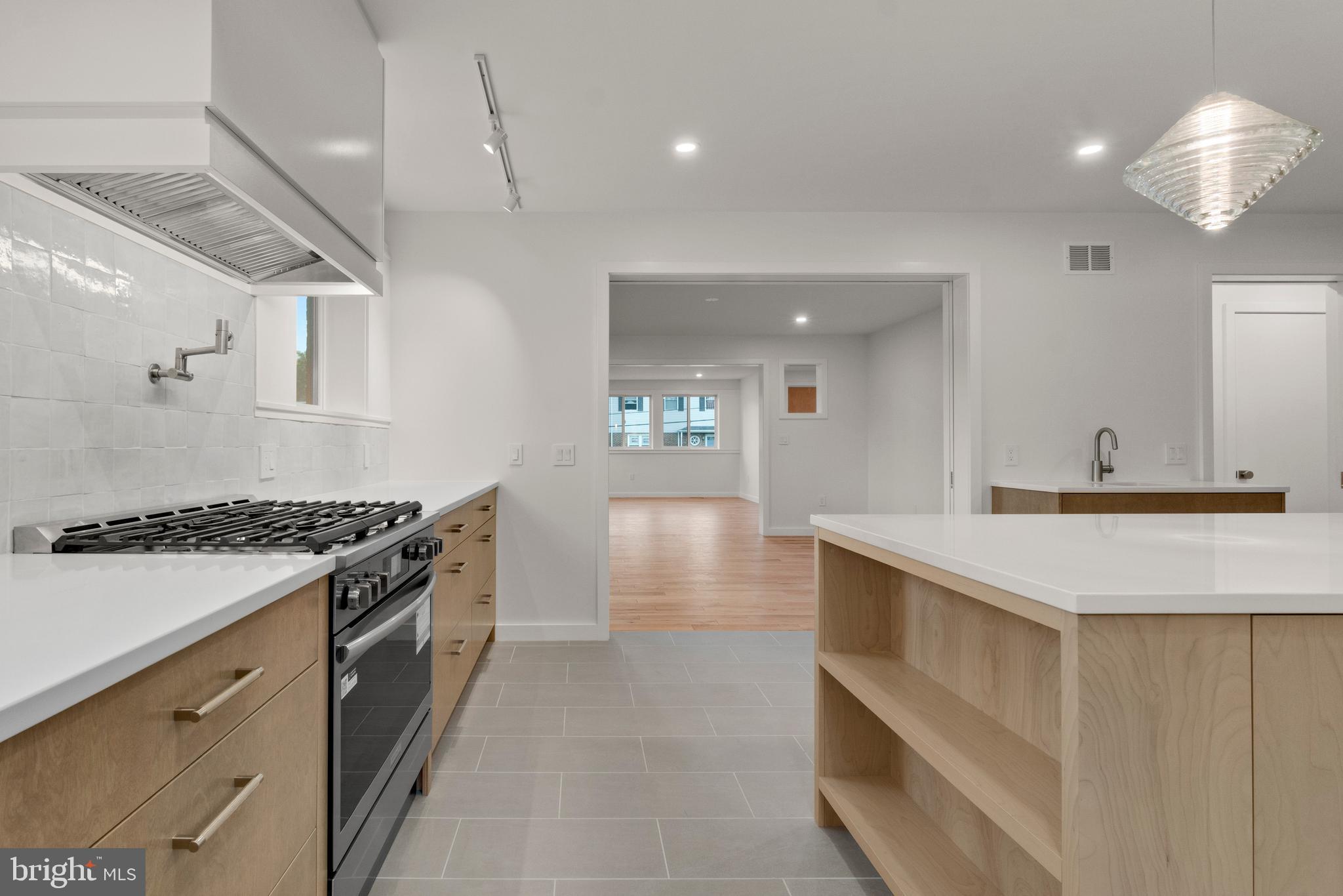 2706 Bartol Avenue Baltimore, MD 21209 - Photo 22 of 62 a kitchen with stainless steel appliances granite countertop a stove and a sink