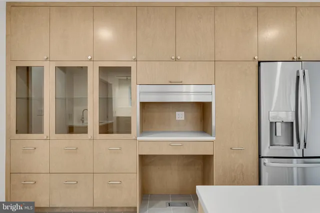 a bathroom with a toilet sink vanity granite and mirror