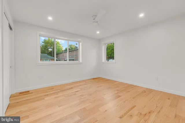 a view of an empty room with wooden floor